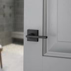 Reserve Square Satin Black Bed/Bath Door Lever with Contemporary Square Rose